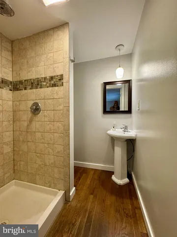 a bathroom with a sink a mirror and a bathtub