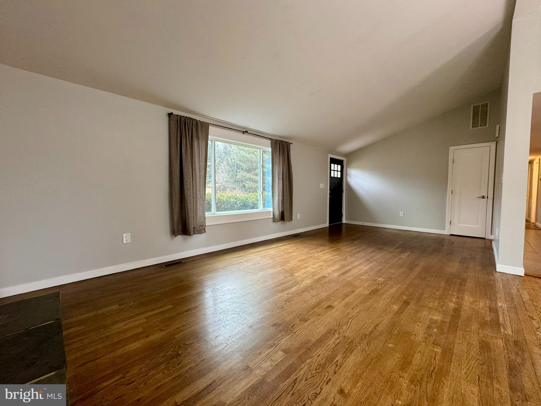 9813 Moyer Road Damascus, MD 20872 - Photo 2 of 31 an empty room with wooden floor and windows