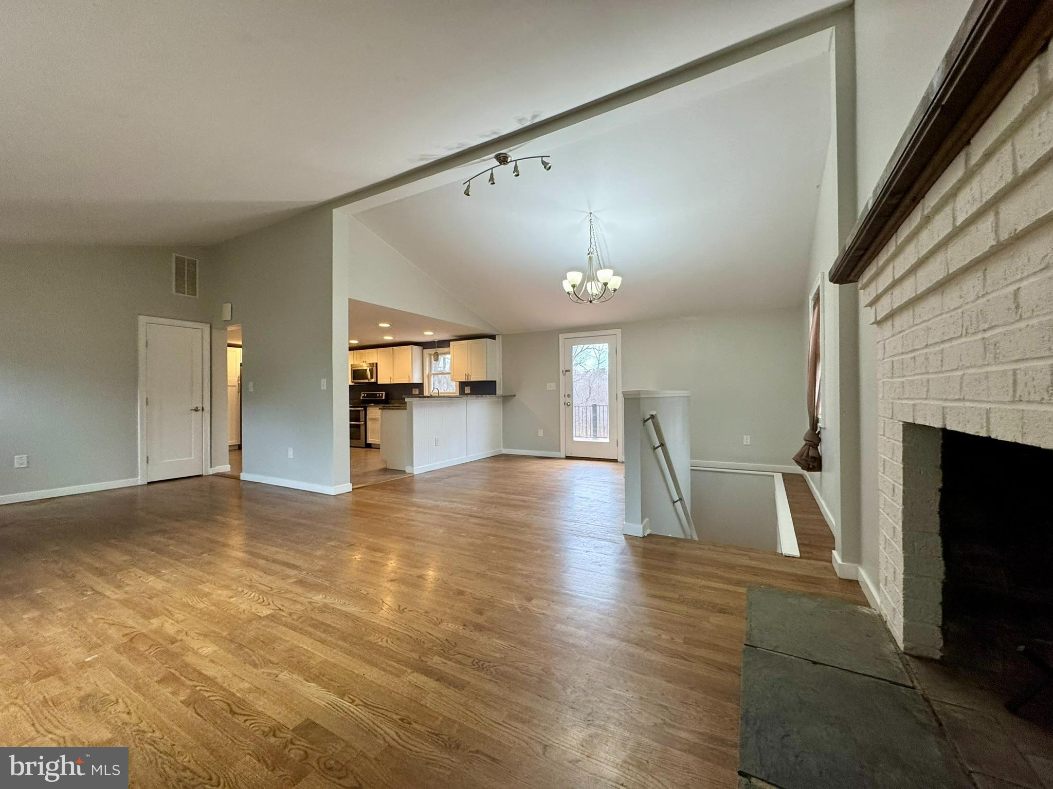 9813 Moyer Road Damascus, MD 20872 - Photo 5 of 31 a view of empty room with wooden floor and fireplace