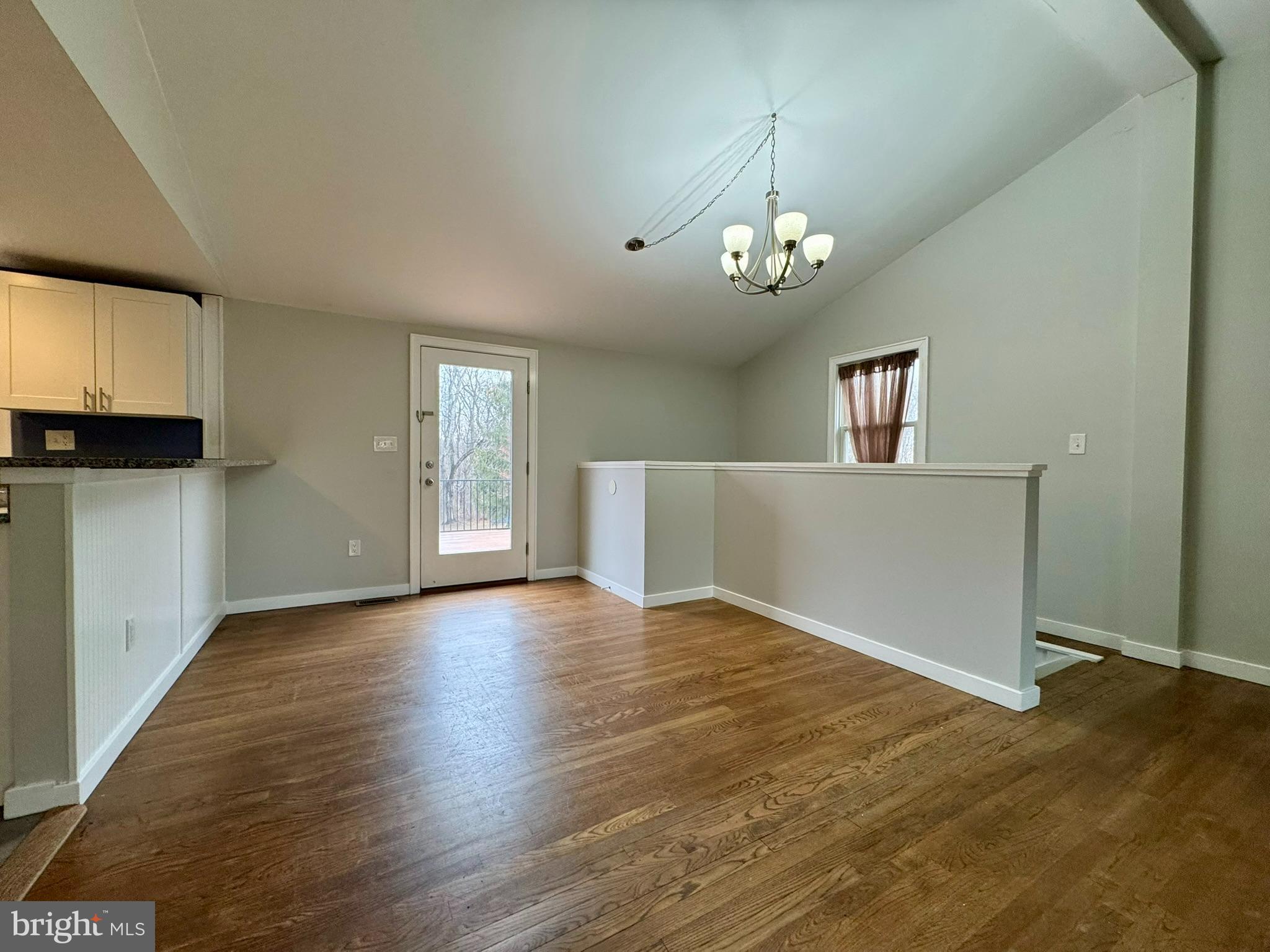 9813 Moyer Road Damascus, MD 20872 - Photo 6 of 31 a view of an empty room with window and wooden floor