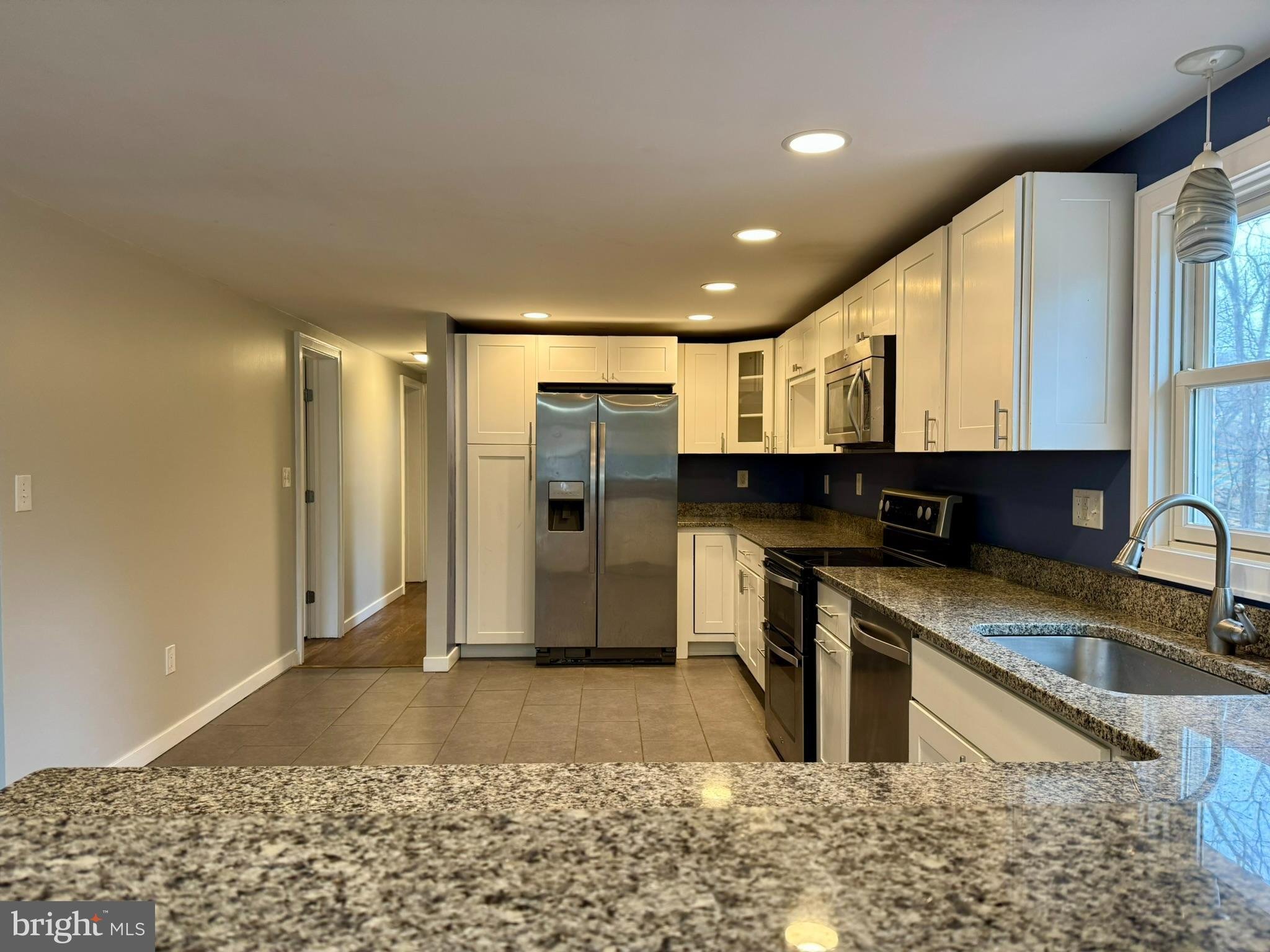 9813 Moyer Road Damascus, MD 20872 - Photo 7 of 31 a kitchen with stainless steel appliances granite countertop a refrigerator a stove a sink and a microwave