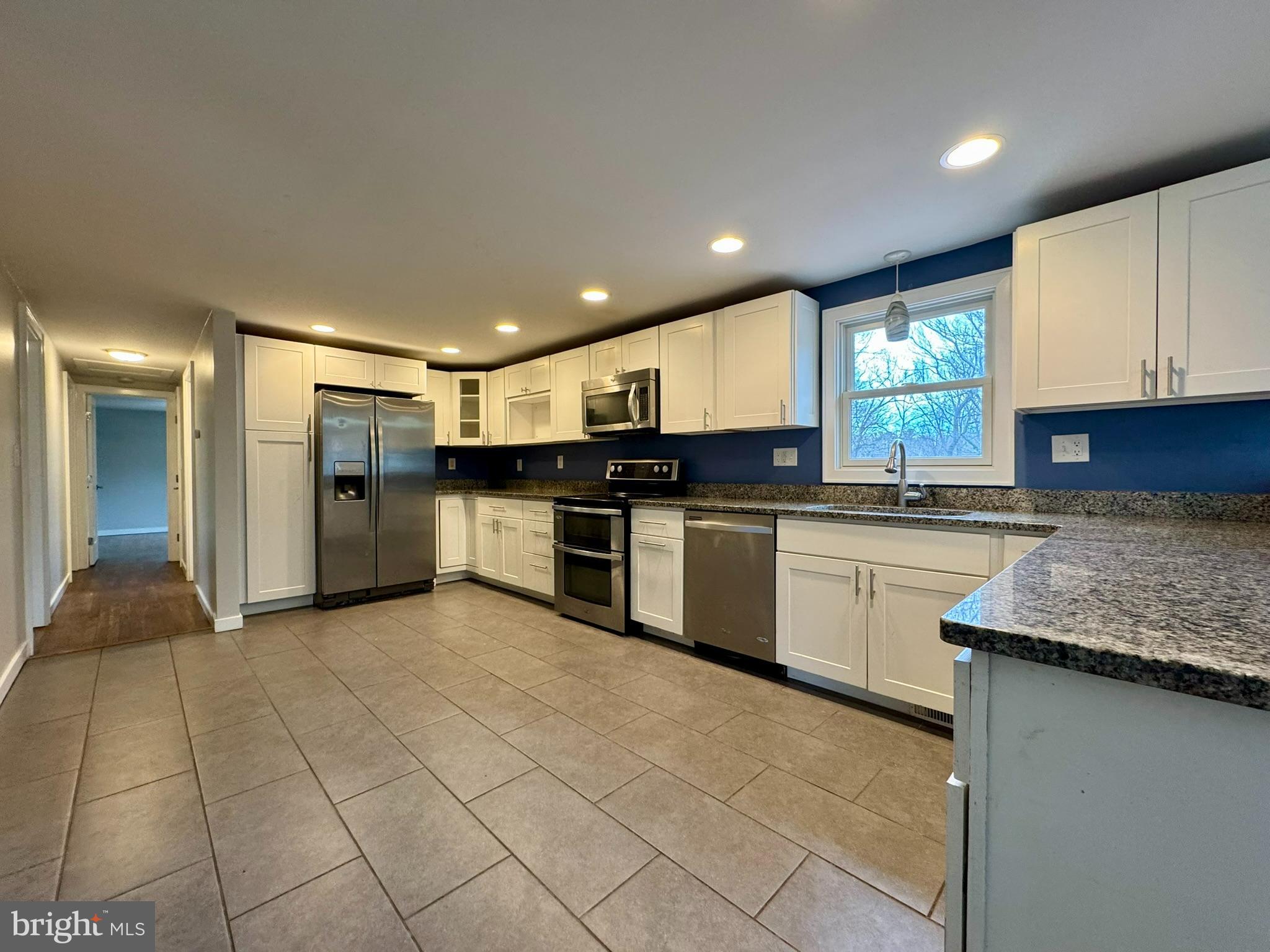 9813 Moyer Road Damascus, MD 20872 - Photo 8 of 31 a large kitchen with stainless steel appliances granite countertop a sink and cabinets