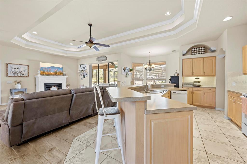 11014 Wren Road Brooksville, FL 34613 - Photo 13 of 50 a living room with furniture a dining table and a view of kitchen
