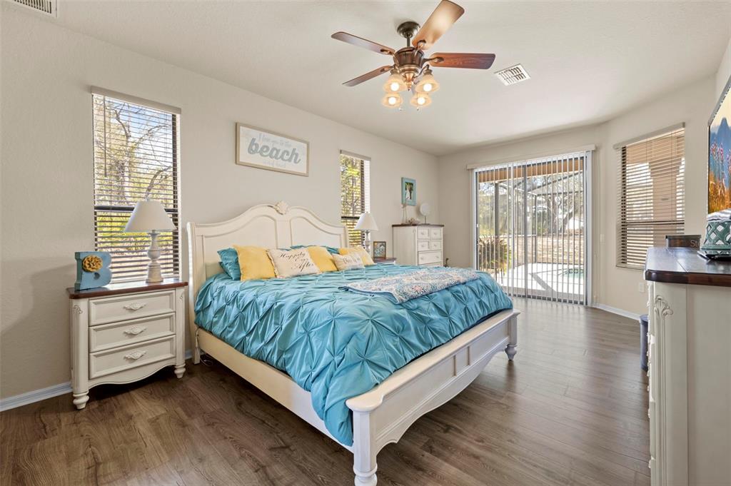 11014 Wren Road Brooksville, FL 34613 - Photo 18 of 50 a bedroom with a bed chandelier and a window