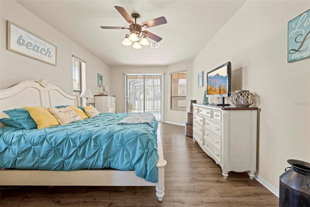 11014 Wren Road Brooksville, FL 34613 - Photo 19 of 50 a bedroom with a bed and a chandelier