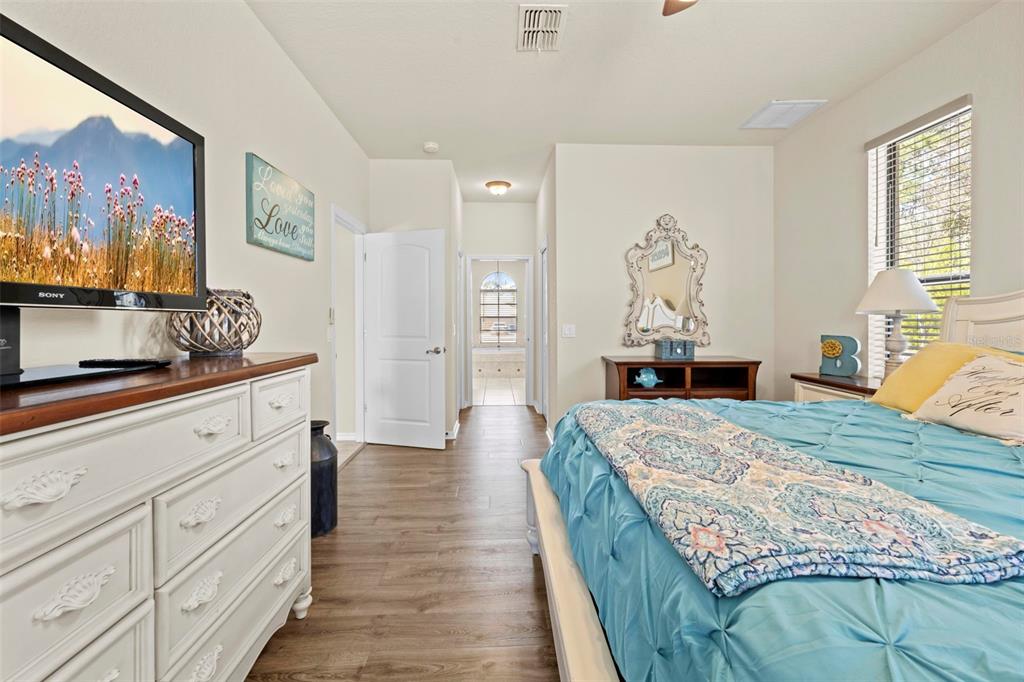 11014 Wren Road Brooksville, FL 34613 - Photo 20 of 50 a spacious bedroom with a bed and a dresser in it