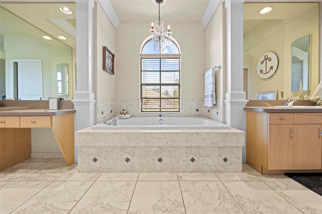 11014 Wren Road Brooksville, FL 34613 - Photo 21 of 50 a spacious bathroom with a tub sink and mirror