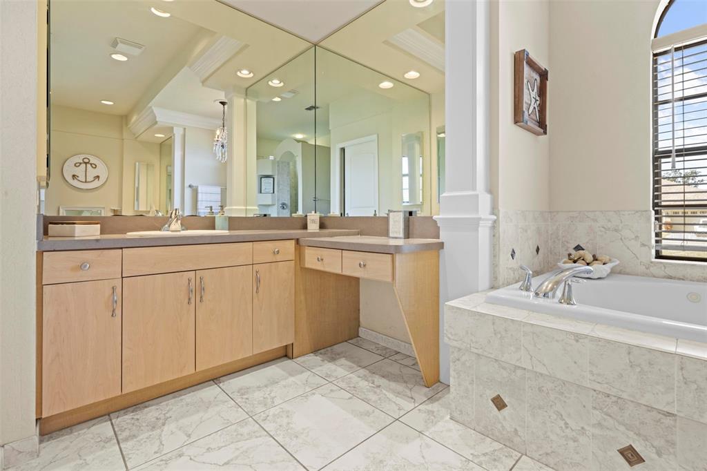 11014 Wren Road Brooksville, FL 34613 - Photo 22 of 50 a spacious bathroom with a sink a mirror and a shower