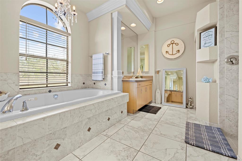 11014 Wren Road Brooksville, FL 34613 - Photo 23 of 50 a spacious bathroom with a tub shower and mirror