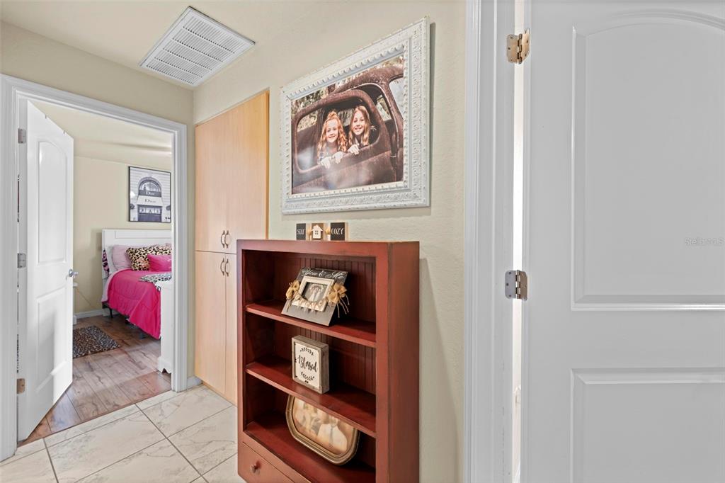 11014 Wren Road Brooksville, FL 34613 - Photo 27 of 50 a bed room with a bed and a painting on the wall