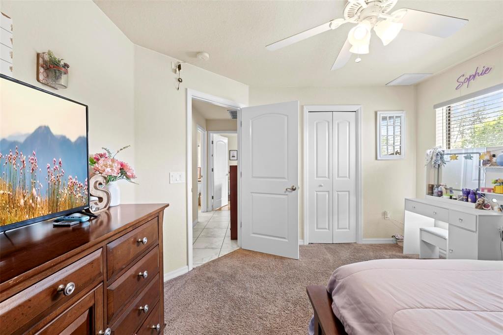 11014 Wren Road Brooksville, FL 34613 - Photo 29 of 50 a bedroom with a bed and a flat screen tv