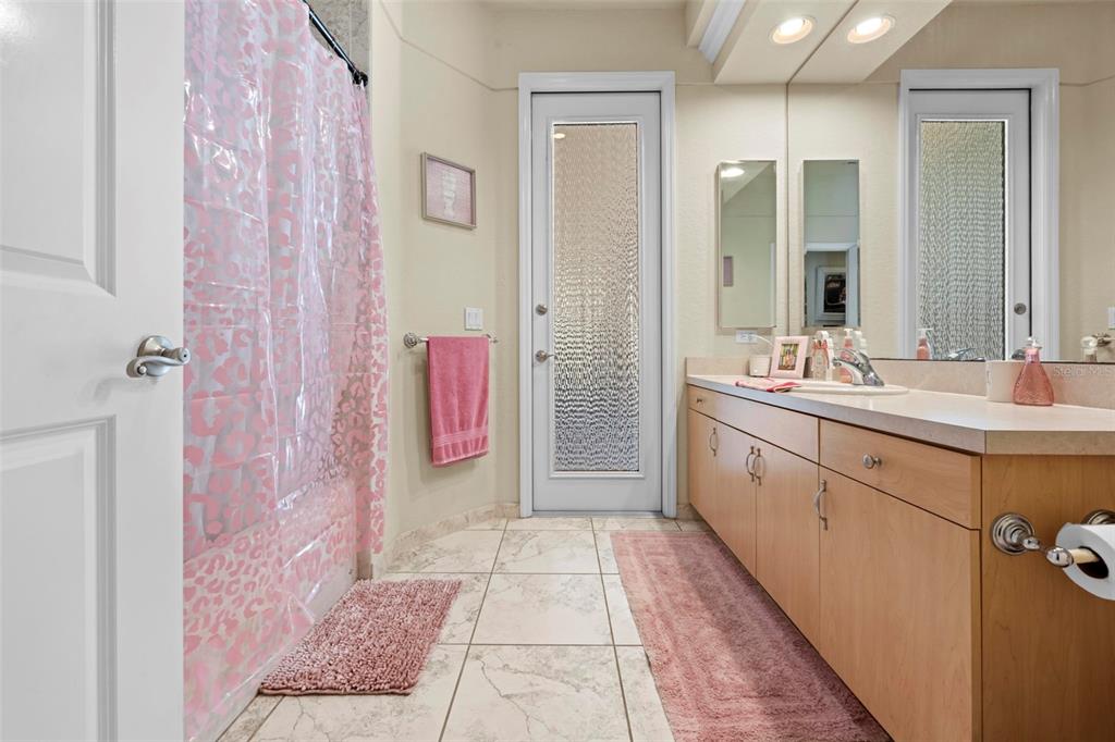 11014 Wren Road Brooksville, FL 34613 - Photo 30 of 50 a bathroom with a sink a mirror and a shower