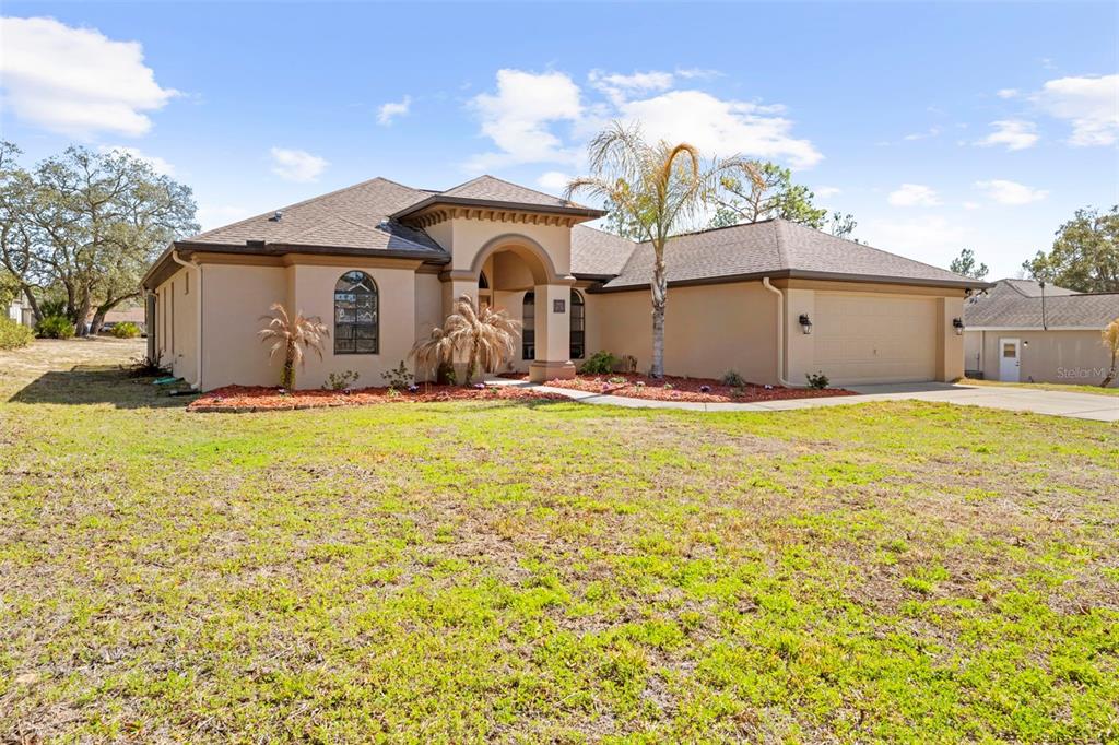 11014 Wren Road Brooksville, FL 34613 - Photo 3 of 50 a front view of a house with yard