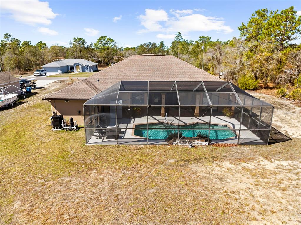 11014 Wren Road Brooksville, FL 34613 - Photo 37 of 50 a view of a house with swimming pool and sitting area
