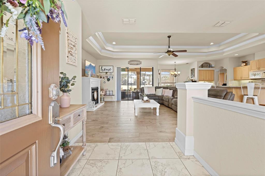 11014 Wren Road Brooksville, FL 34613 - Photo 4 of 50 a living room with fireplace furniture and a view of kitchen