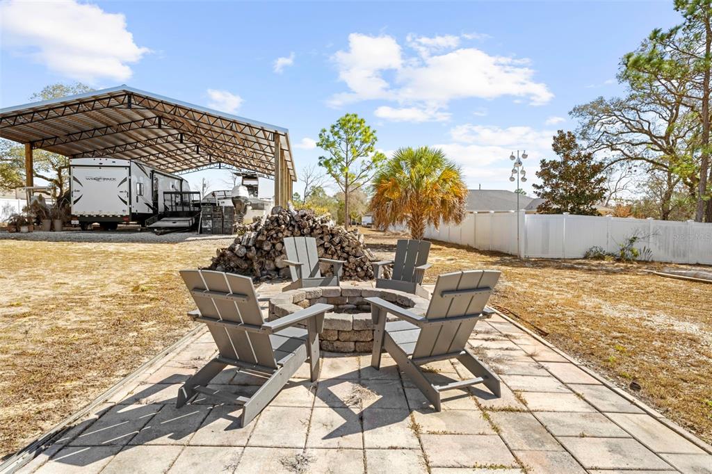 11014 Wren Road Brooksville, FL 34613 - Photo 42 of 50 a view of a patio with swimming pool table and chairs