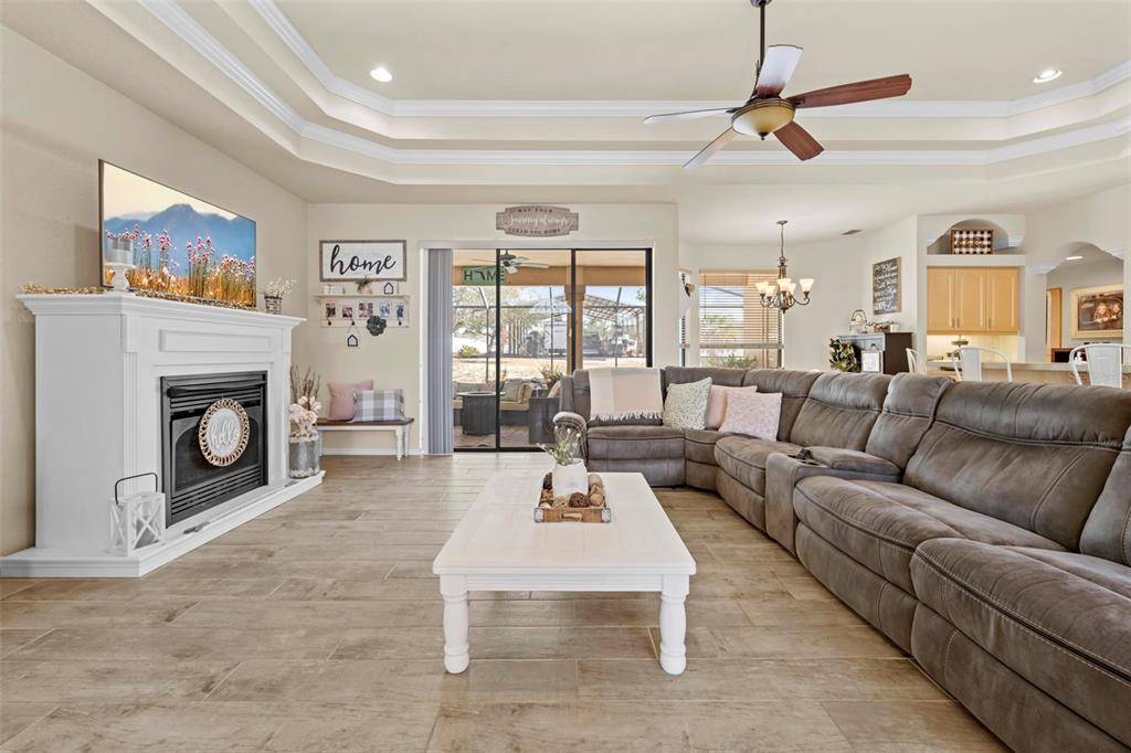 11014 Wren Road Brooksville, FL 34613 - Photo 6 of 50 a living room with furniture large window and a fireplace