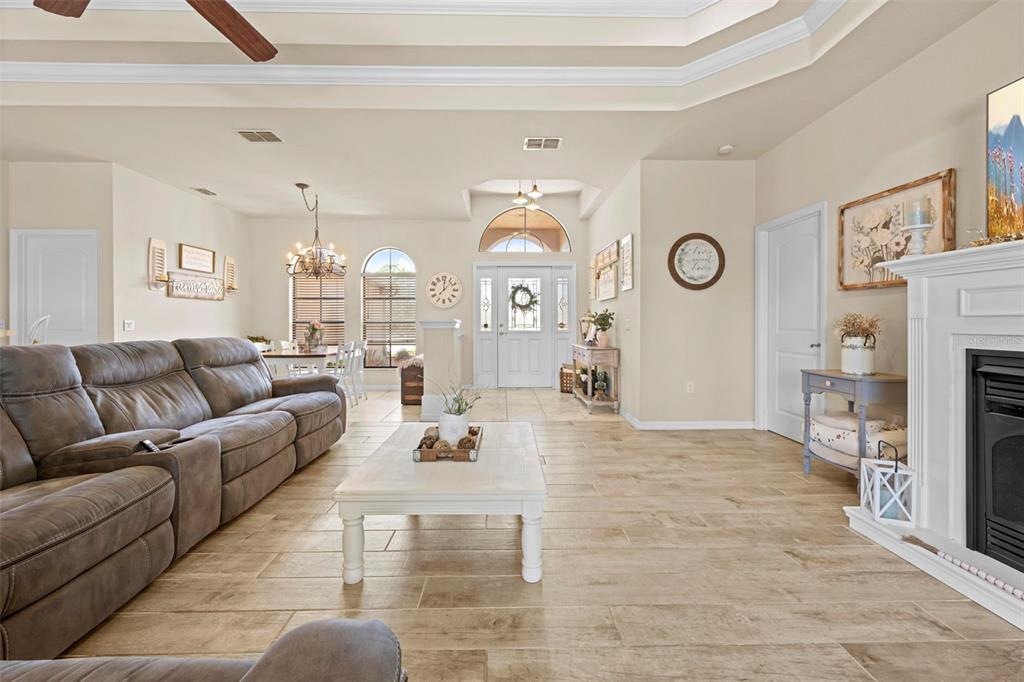 11014 Wren Road Brooksville, FL 34613 - Photo 9 of 50 a living room with furniture a clock and a view of kitchen