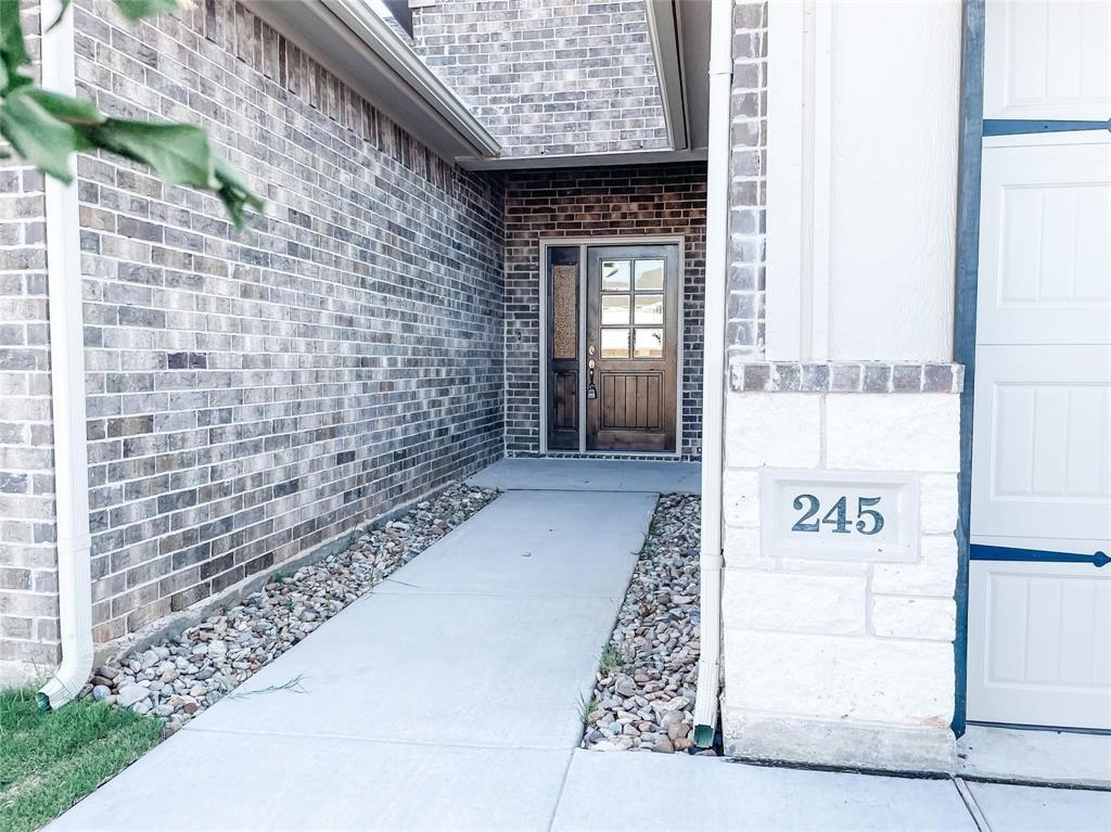 245 Honor Code Place Granbury, TX 76049 - Photo 1 of 16 a view of a brick wall with window