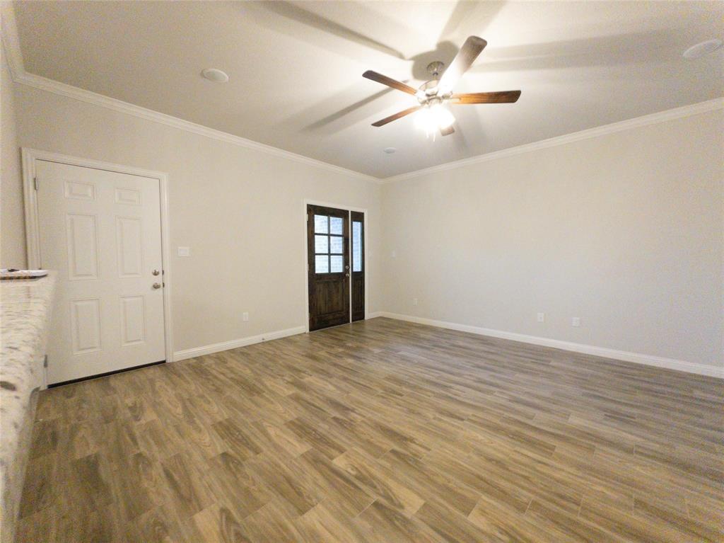 245 Honor Code Place Granbury, TX 76049 - Photo 3 of 16 wooden floor in an empty room
