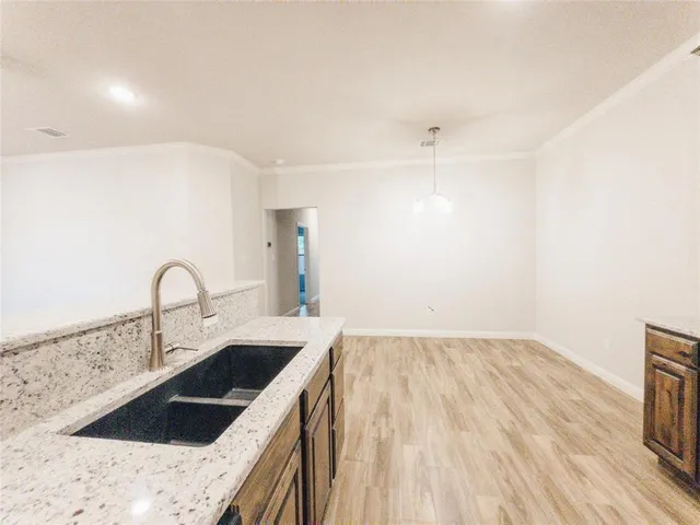 a kitchen with a sink a stove and cabinets