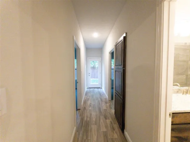 a view of hallway with wooden floor