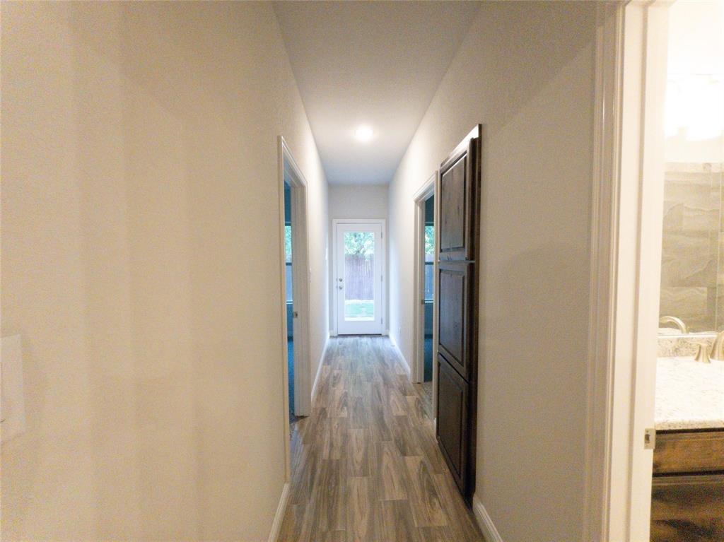 245 Honor Code Place Granbury, TX 76049 - Photo 7 of 16 a view of hallway with wooden floor