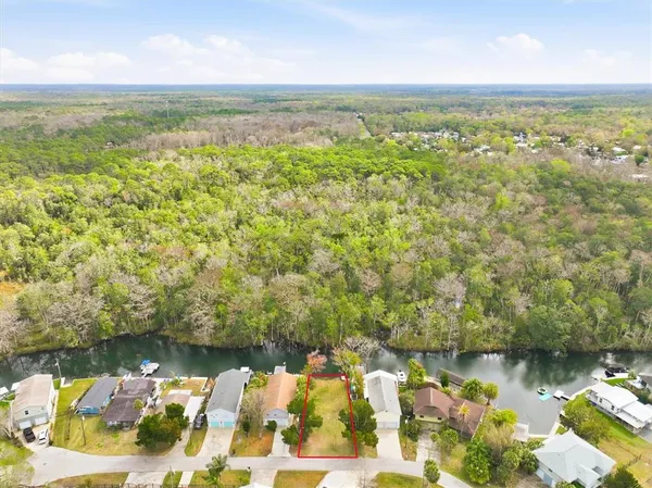 an aerial view of a house with a yard