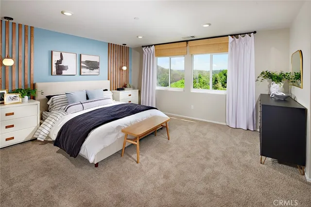 a spacious bedroom with a bed and a window