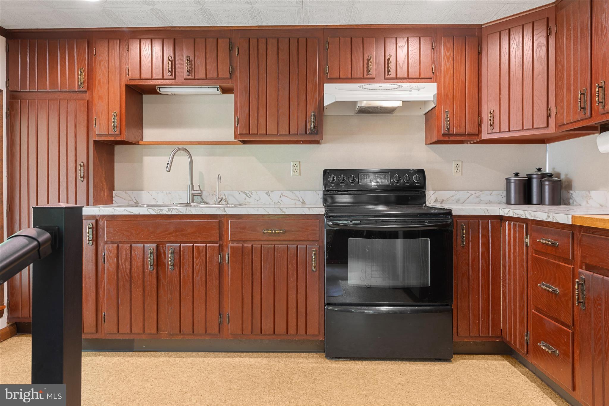 251 Rings End Road Millington, MD 21651 - Photo 8 of 47 a kitchen with granite countertop wood cabinets and stainless steel appliances
