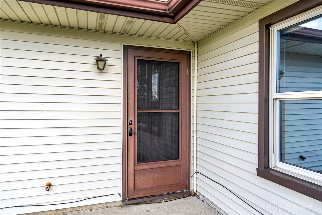 1005 Free Road New Carlisle, OH 45344 - Photo 4 of 43 This exterior view showcases durable siding and a practical entry door, ensuring a welcoming facade.