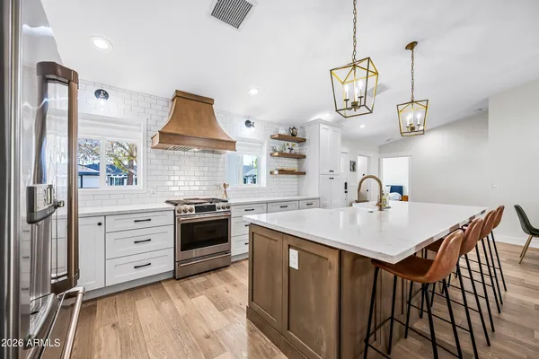 a kitchen with a stove a refrigerator and a sink