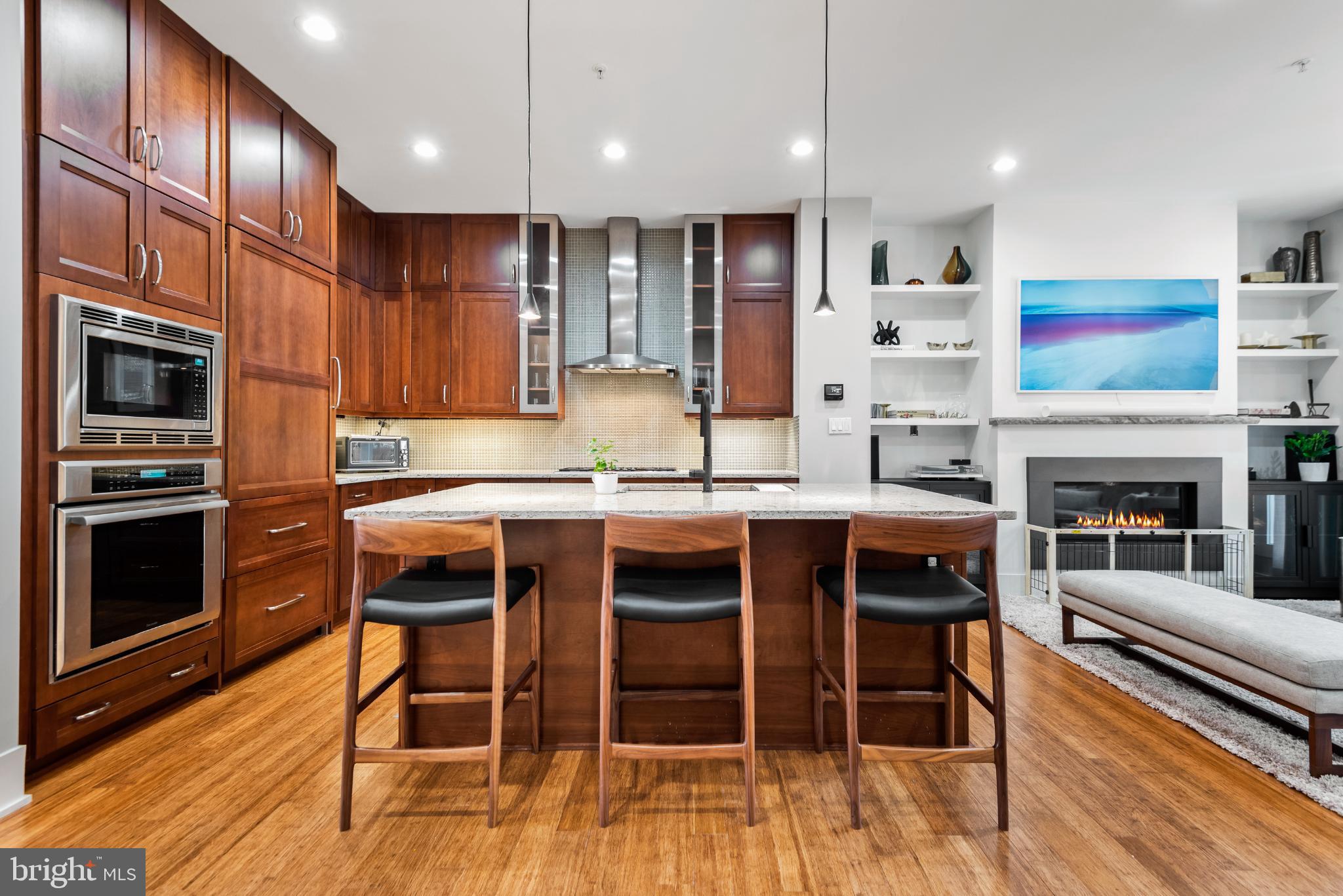 5117 Willet Bridge Road Bethesda, MD 20816 - Photo 16 of 46 a kitchen with a table chairs microwave and cabinets