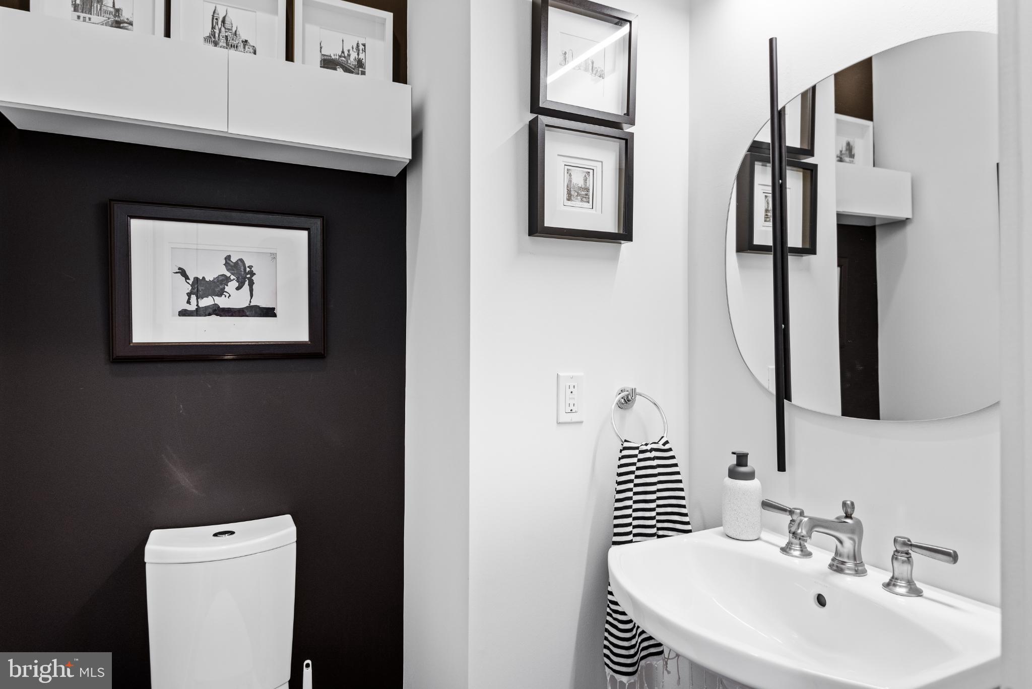 5117 Willet Bridge Road Bethesda, MD 20816 - Photo 24 of 46 a bathroom with a sink a toilet and mirror