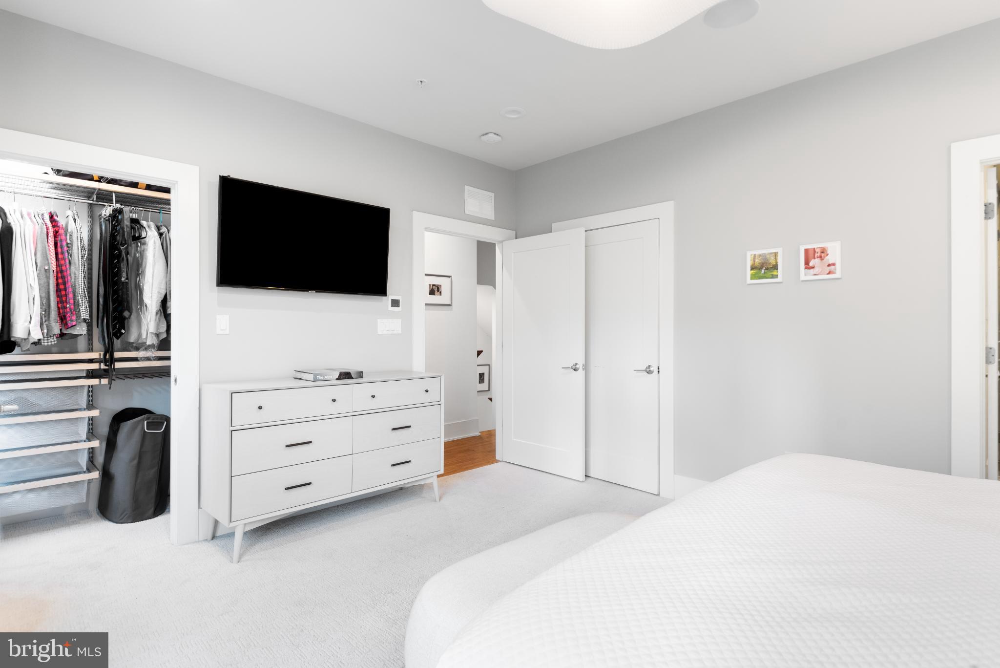 5117 Willet Bridge Road Bethesda, MD 20816 - Photo 27 of 46 a bedroom with a bed and a flat screen tv