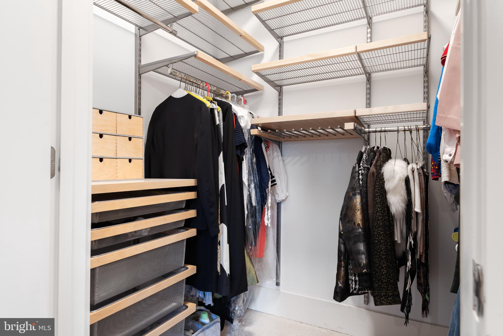 5117 Willet Bridge Road Bethesda, MD 20816 - Photo 28 of 46 a view of walk in closet with clothes and shoes