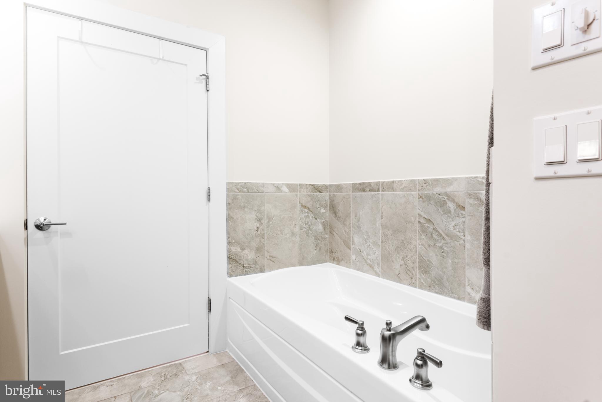 5117 Willet Bridge Road Bethesda, MD 20816 - Photo 29 of 46 a bathroom with a bathtub