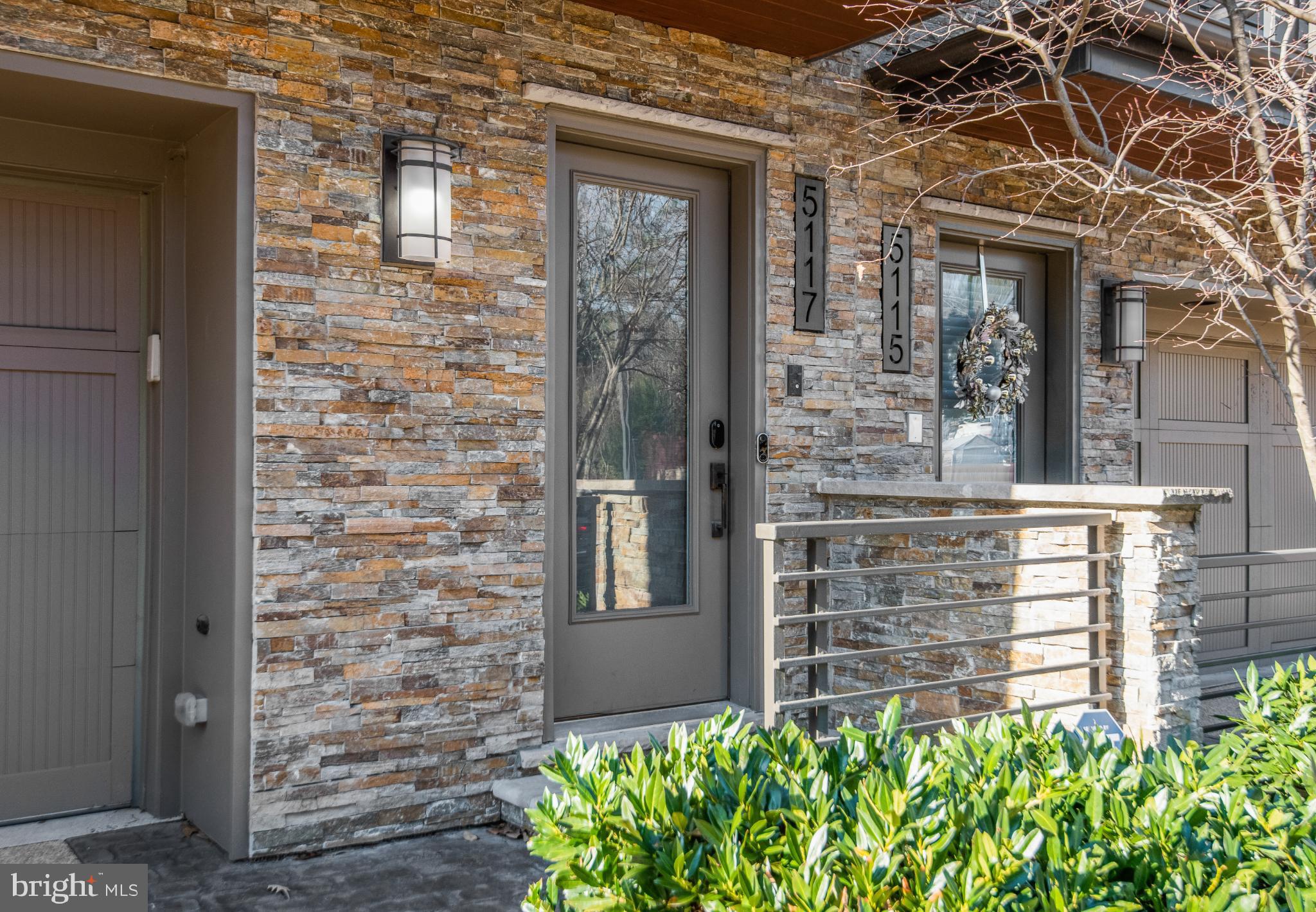 5117 Willet Bridge Road Bethesda, MD 20816 - Photo 3 of 46 front view of a brick house with a large windows