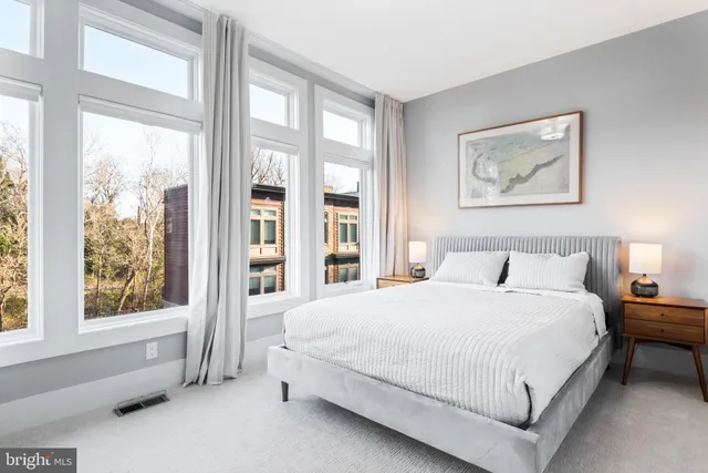 a bedroom with a large bed and a large window