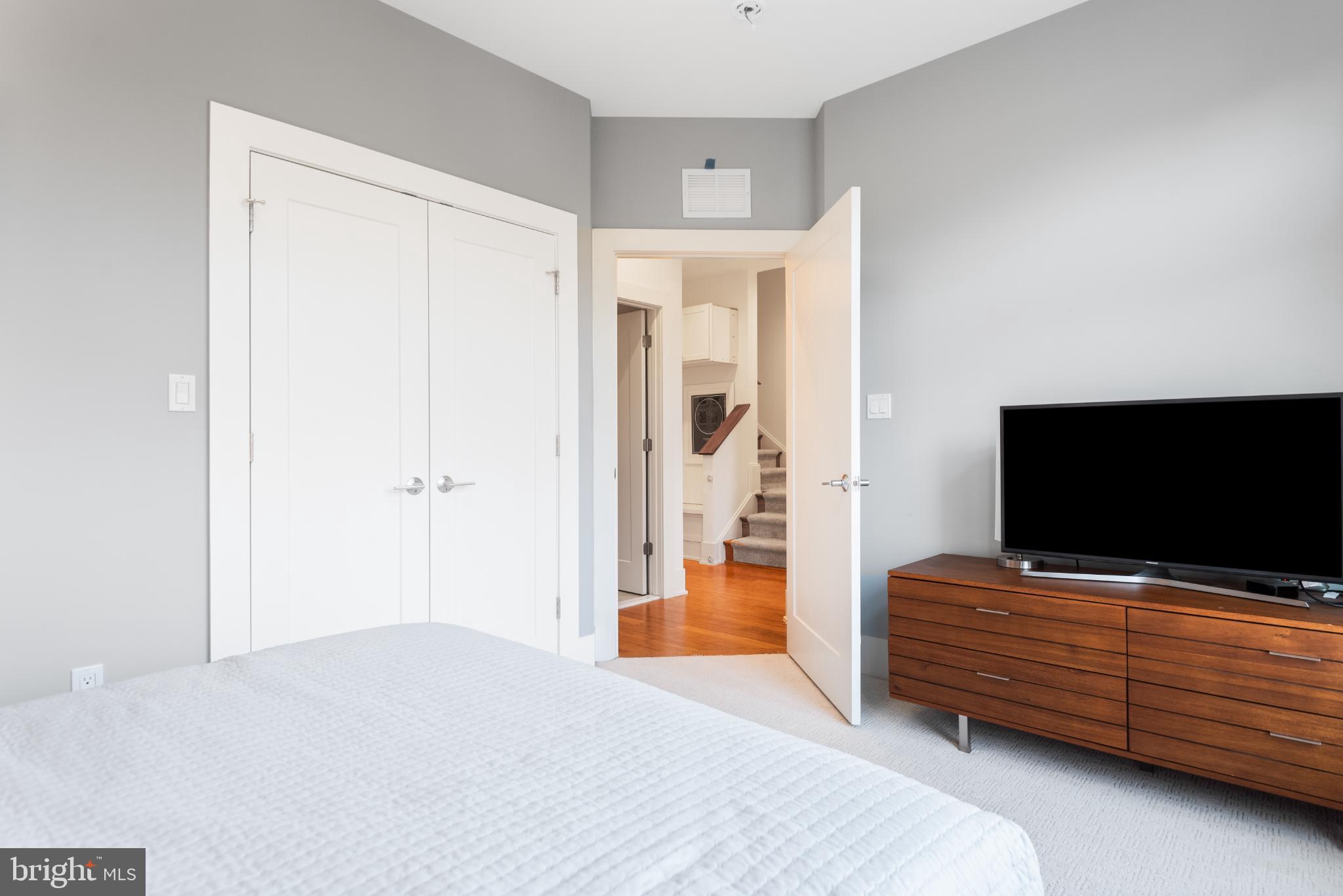 5117 Willet Bridge Road Bethesda, MD 20816 - Photo 32 of 46 a bedroom with furniture and flat screen tv