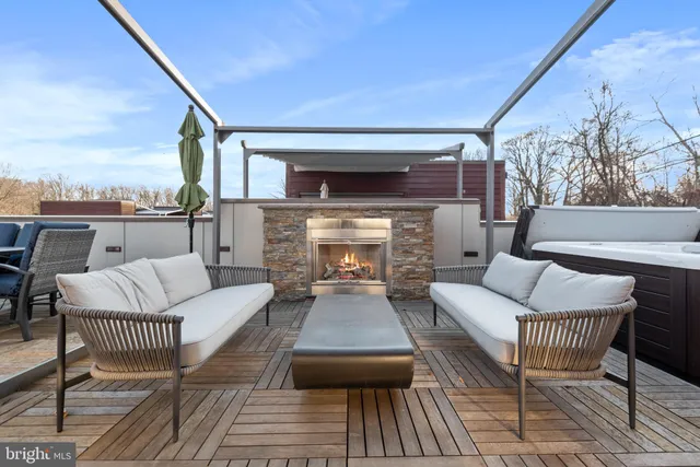 a balcony with furniture and a fireplace