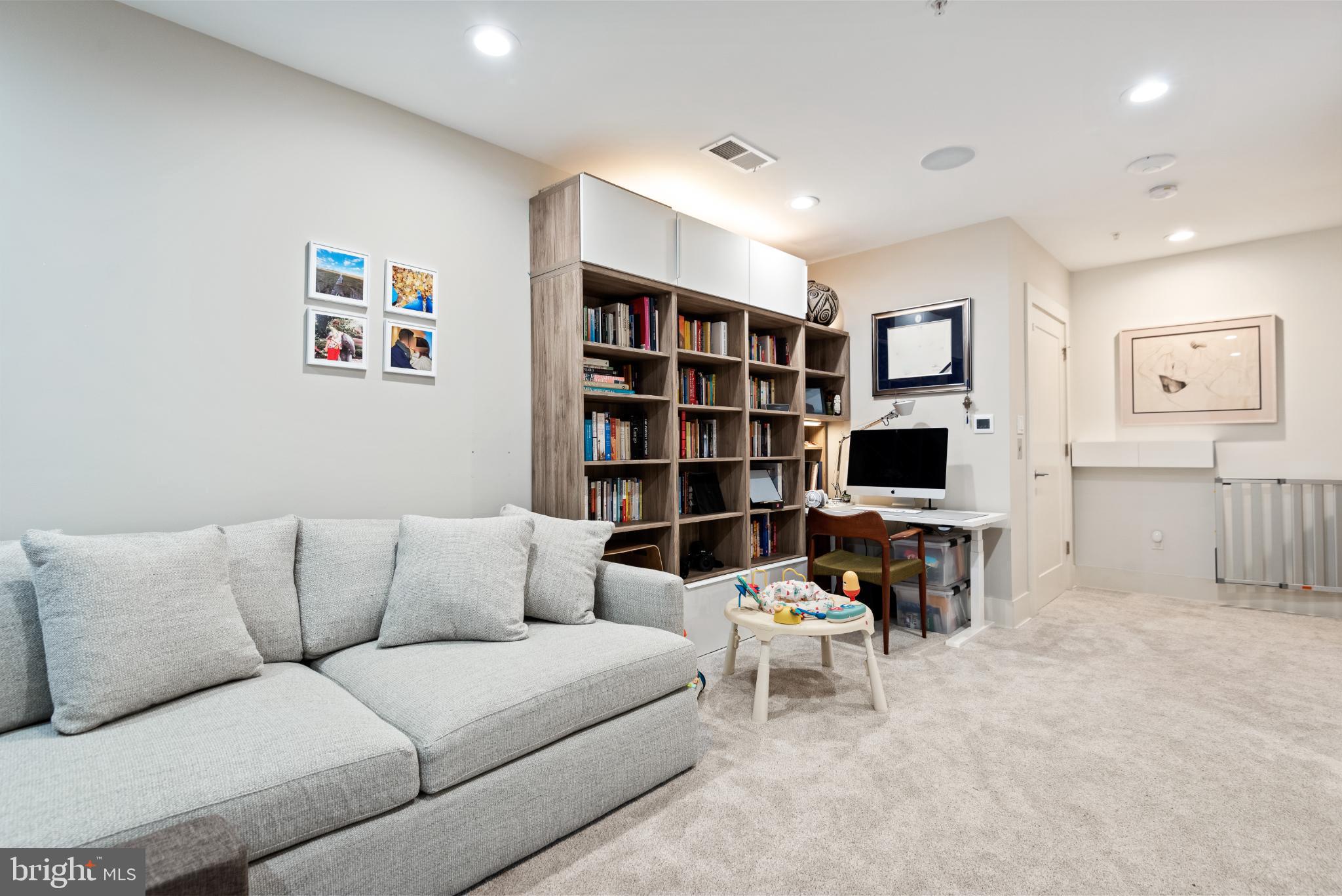 5117 Willet Bridge Road Bethesda, MD 20816 - Photo 44 of 46 a living room with furniture and a flat screen tv