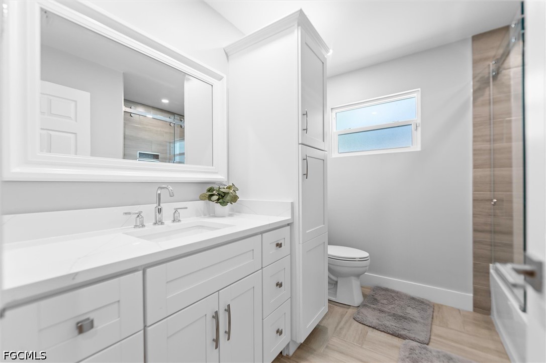 1200 Patterson Road Cape Coral, FL 33909 - Photo 16 of 42 a bathroom with a granite countertop sink a toilet and a mirror