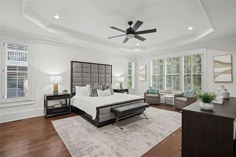 a kitchen with stainless steel appliances a stove a sink a oven a dining table and chairs with wooden floor