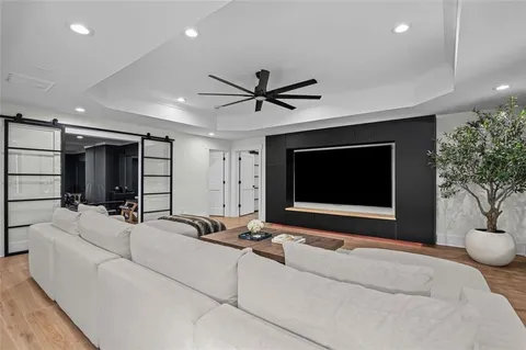 a living room with furniture and wooden floor