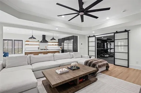 a bedroom with a bed a window and a chandelier