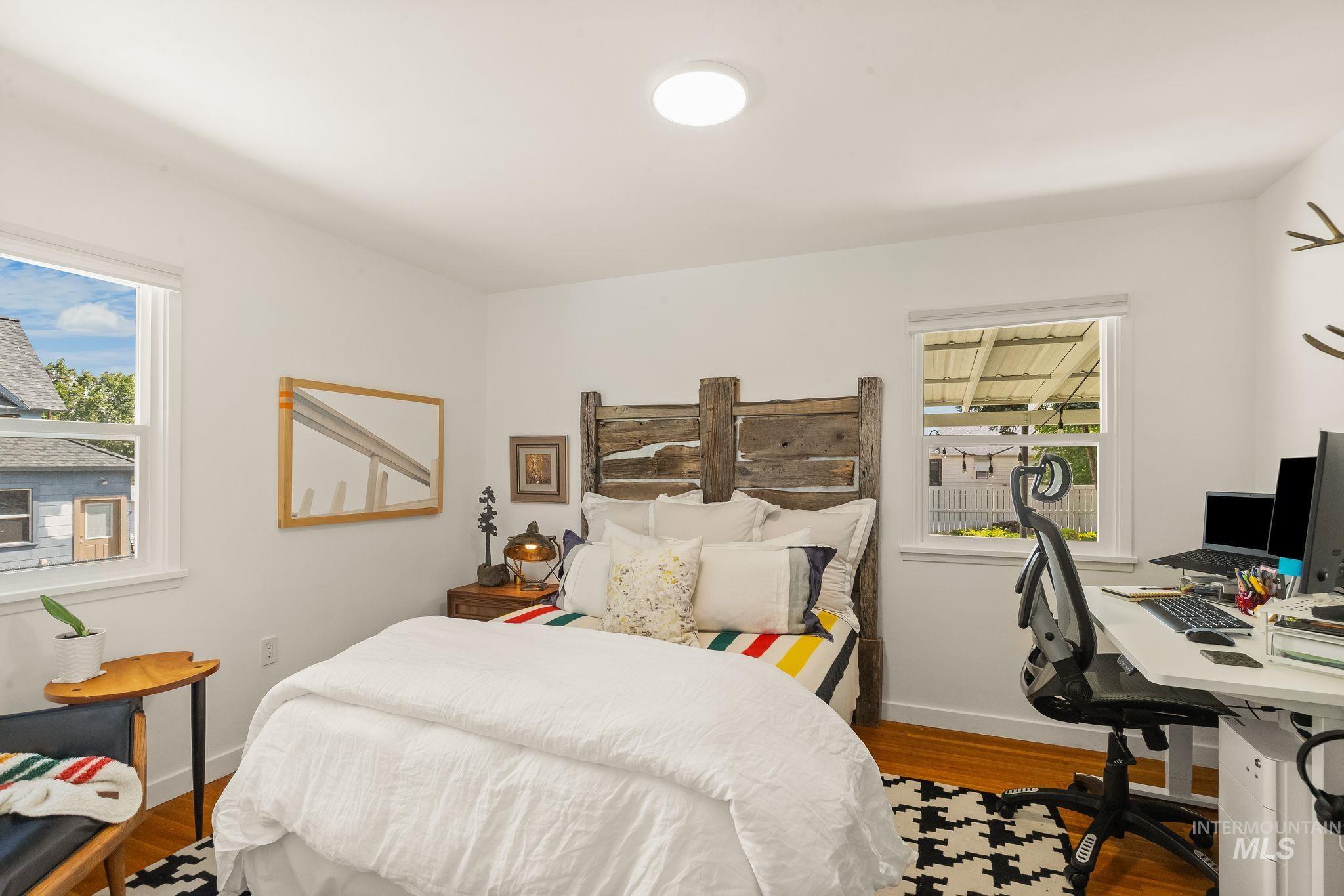 1315 8th Street Clarkston, WA 99403 - Photo 21 of 37 Bedroom featuring wood-finish flooring, white walls, and a contemporary ceiling light fixture