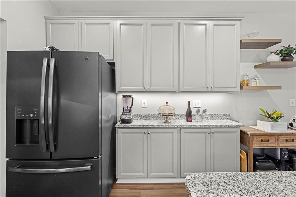 230 Augusta Walk Canton, GA 30114 - Photo 19 of 56 a kitchen with stainless steel appliances kitchen island a refrigerator sink and cabinets