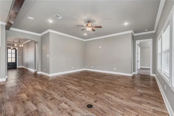 wooden floor in an empty room with a window
