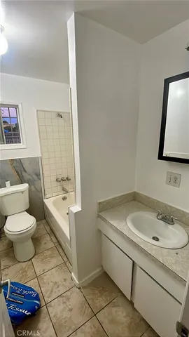 a bathroom with a sink toilet and a mirror